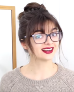 cute messy bun with bangs and glasses