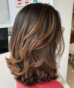 Mid length hairstyle with flicked ends